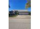 Charming single-story home with a two-car garage and well-maintained front yard under a clear blue sky at 5261 Camberlea Ave, Zephyrhills, FL 33541
