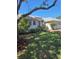 Charming single-story home featuring a well-maintained lawn and lush landscaping at 5261 Camberlea Ave, Zephyrhills, FL 33541