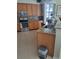 Open-concept kitchen with granite countertops, tile backsplash, and stainless steel appliances at 5261 Camberlea Ave, Zephyrhills, FL 33541