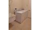 Functional laundry room with a utility sink and white washer and dryer at 5261 Camberlea Ave, Zephyrhills, FL 33541
