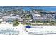 Wide aerial shot of the beach resort with a large water slide on the beach and Gulf waters on a sunny day at 5500 Gulf Blvd # 4226, St Pete Beach, FL 33706