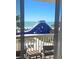 Balcony view with a clear ocean and a giant blue inflatable water slide on a white sand beach at 5500 Gulf Blvd # 4226, St Pete Beach, FL 33706