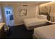 Comfortable bedroom with two beds, stylish decor, and a view into the living area for a relaxing stay at 5500 Gulf Blvd # 4226, St Pete Beach, FL 33706