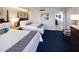 Cozy bedroom featuring two queen beds, stylish decor, and a glimpse into the kitchen at 5500 Gulf Blvd # 4226, St Pete Beach, FL 33706