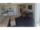 Open-concept living room with a kitchen, couch, dining table, and seamless flooring at 5500 Gulf Blvd # 4226, St Pete Beach, FL 33706