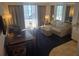 Cozy living room with a sofa, table, ottomans, and a large window offering a view of the ocean at 5500 Gulf Blvd # 4226, St Pete Beach, FL 33706