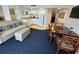Well-lit living room and kitchen featuring modern furniture, a dining table, and plenty of space at 5500 Gulf Blvd # 4226, St Pete Beach, FL 33706