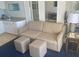 Inviting living room featuring a comfortable sofa, ottomans, and a kitchenette with ample counter space at 5500 Gulf Blvd # 4226, St Pete Beach, FL 33706