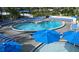 Inviting kidney-shaped pool with ample lounge chairs and shade umbrellas for a relaxing vacation experience at 5500 Gulf Blvd # 4226, St Pete Beach, FL 33706