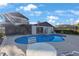 The backyard features a large in-ground pool, hot tub, covered patio and spiral staircase leading to a private balcony at 5938 Oakhurst Dr, Seminole, FL 33772