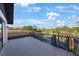 Enjoy the view of surrounding greenery from this home's balcony with black metal railings and a gate for safety at 5938 Oakhurst Dr, Seminole, FL 33772