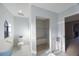 Bright bathroom features a shower with a built-in seat, and a unique arched window for natural lighting at 5938 Oakhurst Dr, Seminole, FL 33772