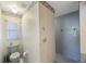 Bathroom featuring toilet, tiled floors, shower, and window with bright light at 5938 Oakhurst Dr, Seminole, FL 33772