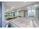 Bathroom features a mirrored wall, soaking tub, with plants at 5938 Oakhurst Dr, Seminole, FL 33772