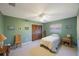 Green bedroom with a bed, side table, and chair, offering a peaceful and relaxing retreat at 5938 Oakhurst Dr, Seminole, FL 33772