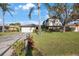 Inviting two-story home with lush lawn, mature trees, and a welcoming mailbox at 5938 Oakhurst Dr, Seminole, FL 33772