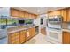 Functional kitchen with stainless steel appliances, granite countertops, and wood cabinets at 5938 Oakhurst Dr, Seminole, FL 33772