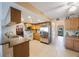 Spacious kitchen with stainless steel appliances, tiled floor and wood cabinets at 5938 Oakhurst Dr, Seminole, FL 33772