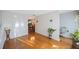 Bright room featuring wood floors, with a glimpse into the dining area at 5938 Oakhurst Dr, Seminole, FL 33772