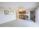 Bright living area featuring a wet bar with a cozy seating area and neutral carpeting at 5938 Oakhurst Dr, Seminole, FL 33772