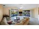 Bright living room with vaulted ceiling, glass doors to pool and lanai, ceiling fan, and comfortable seating at 5938 Oakhurst Dr, Seminole, FL 33772