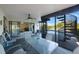 The covered patio overlooks a beautiful pool, manicured lawn, and features a spiral staircase to the home's second floor at 5938 Oakhurst Dr, Seminole, FL 33772