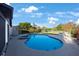 Refreshing pool with hot tub and ample patio space is perfect for relaxation or entertaining in a tropical setting at 5938 Oakhurst Dr, Seminole, FL 33772