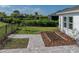 Well manicured backyard featuring a small garden, new sod, and brick paver walkway at 6185 Hidden Branch Dr, Apollo Beach, FL 33572