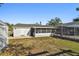 Backyard with a large screened enclosure in addition to storage building at 6712 Runningwoods Dr, Tampa, FL 33634