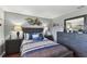 Bedroom with queen-sized bed, matching nightstands, hardwood floors and modern decor at 6712 Runningwoods Dr, Tampa, FL 33634