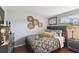 Bedroom features hardwood floors, a queen-sized bed, a window, and woven decor at 6712 Runningwoods Dr, Tampa, FL 33634