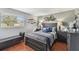 Bedroom features a queen-sized bed, hardwood floors, and plenty of natural light at 6712 Runningwoods Dr, Tampa, FL 33634