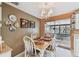 Cozy dining area featuring a classic wooden table set with decorative plates and artwork, creating an inviting ambiance at 6712 Runningwoods Dr, Tampa, FL 33634