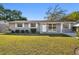 Charming single-story home with well-maintained lawn and exterior, complemented by lush landscaping at 6712 Runningwoods Dr, Tampa, FL 33634