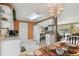 Eat-in kitchen featuring white appliances, tile floors, and an adjacent dining area for a casual meal at 6712 Runningwoods Dr, Tampa, FL 33634