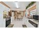 Open-concept kitchen with white cabinets, modern appliances, and an eat-in dining area, perfect for Gathering meals at 6712 Runningwoods Dr, Tampa, FL 33634