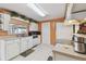 Bright kitchen featuring white cabinets, tile floors, and modern appliances for a clean and functional space at 6712 Runningwoods Dr, Tampa, FL 33634