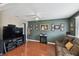 Comfortable living room with hardwood floors, ceiling fan, and personal photos creating a warm and inviting atmosphere at 6712 Runningwoods Dr, Tampa, FL 33634