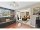 Bright living room with large windows, hardwood floors, ceiling fan, and comfortable seating arrangement at 6712 Runningwoods Dr, Tampa, FL 33634