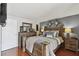 Comfortable bedroom with a rustic wooden bed frame, stylish decor, and warm lighting for a relaxing ambiance at 6712 Runningwoods Dr, Tampa, FL 33634