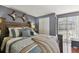 Comfortable bedroom with a rustic wooden bed frame, stylish decor, and warm lighting for a relaxing ambiance at 6712 Runningwoods Dr, Tampa, FL 33634