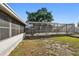 Wide angle view of large screened patio area in the backyard with clear skies above at 6712 Runningwoods Dr, Tampa, FL 33634