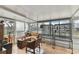 Bright sunroom with neutral tile flooring, a seating area, and two large bird cages at 6712 Runningwoods Dr, Tampa, FL 33634