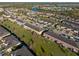 An aerial view of townhomes with manicured lawns, mature trees, and nearby amenities at 7047 Towne Lake Rd, Riverview, FL 33578