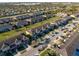 An aerial view of colorful townhomes with lush lawns, tree-lined streets, and ample parking, creating a vibrant community atmosphere at 7047 Towne Lake Rd, Riverview, FL 33578