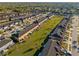 An aerial view showcases tan townhomes with garages and nearby visitor parking, with well-maintained lawns in the community at 7047 Towne Lake Rd, Riverview, FL 33578
