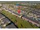 Aerial view of a townhome featuring front garages and lawns, visitor parking, and convenient access to nearby amenities at 7047 Towne Lake Rd, Riverview, FL 33578