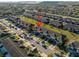 An aerial view showcases tan townhomes with garages and nearby visitor parking, with well-maintained lawns in the community at 7047 Towne Lake Rd, Riverview, FL 33578