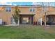 Backyard featuring a screened lanai, lawn, and mature trees at 7047 Towne Lake Rd, Riverview, FL 33578