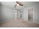 Bedroom featuring neutral carpet, a ceiling fan and a walk in closet at 7047 Towne Lake Rd, Riverview, FL 33578